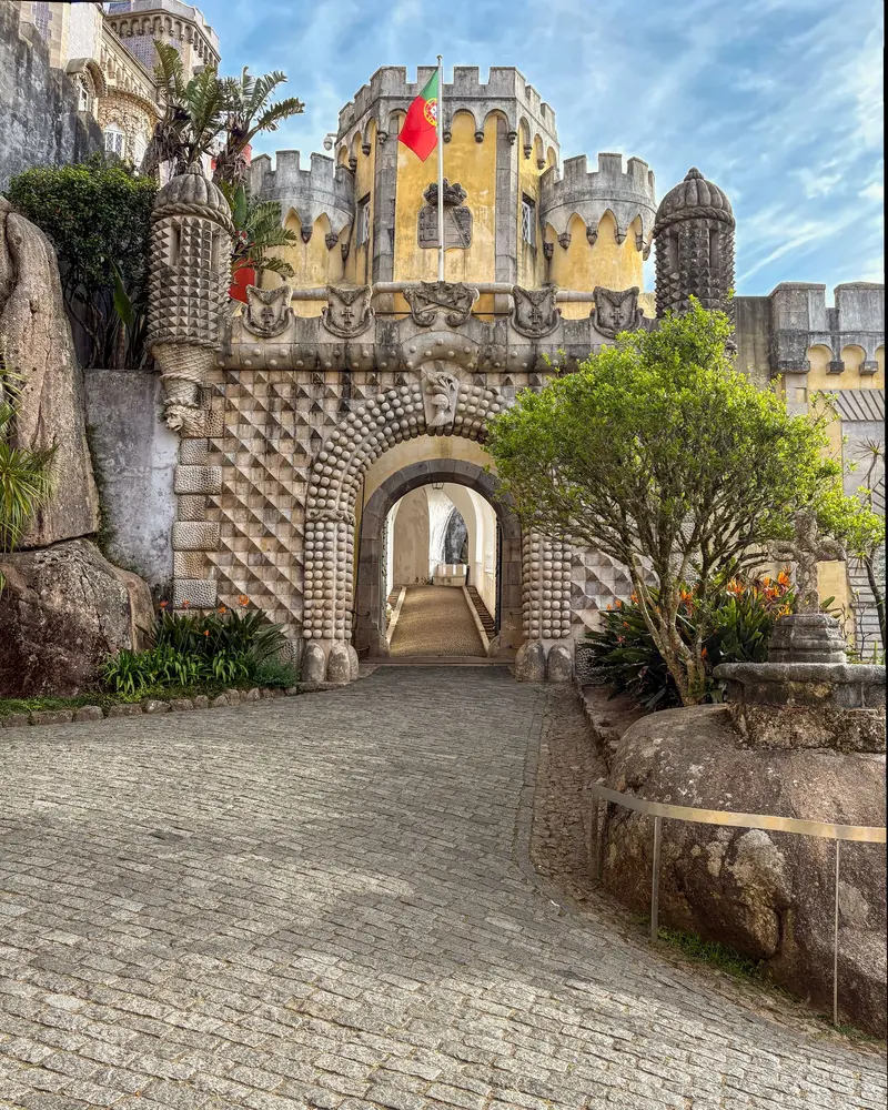 The cobbled entrance arch at Pena Palace, with the Triton gateway above